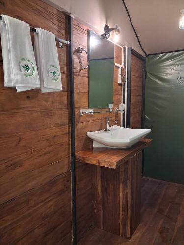 a bathroom with a sink and a mirror at Wilpattu Wilderness Camping in Wilpattu