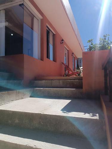 a building with steps next to a house at Sol y Luna in Comunidad Yumani