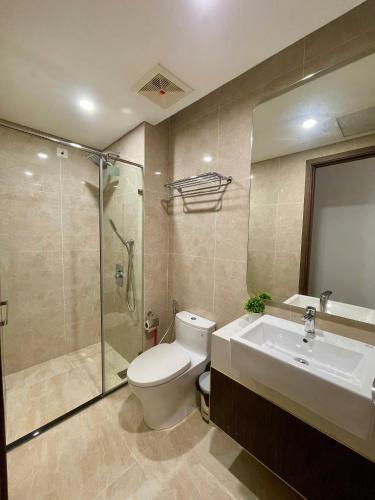 a bathroom with a toilet and a sink and a shower at HERE Stay in An Khê