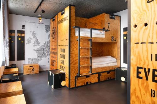 a room with a bunk bed with a ladder at stories by Grimm's in Münster