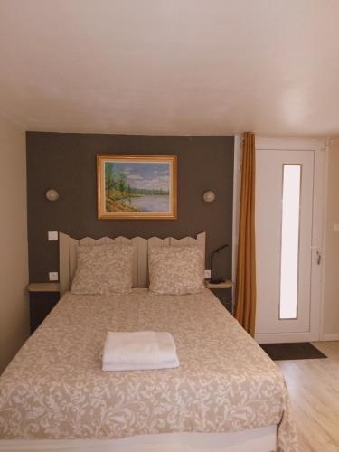 a bedroom with a bed with a white blanket at perigordchambre in Sarlat-la-Canéda