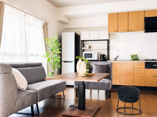 a living room with a couch and a table at サンヒルズマンション in Tosu