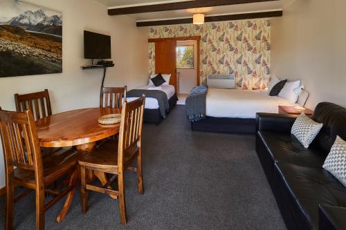 a living room with a table and a couch at Glentanner Park Centre in Glentanner