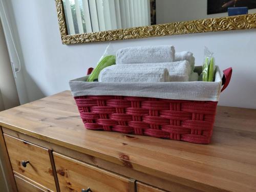 a basket of towels on a dresser in front of a mirror at VIP Lounge in Settimo Milanese
