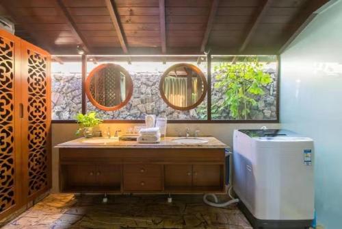 a bathroom with a sink and a refrigerator at 三亚亚龙湾伊墅情怀旅租 in Sanya
