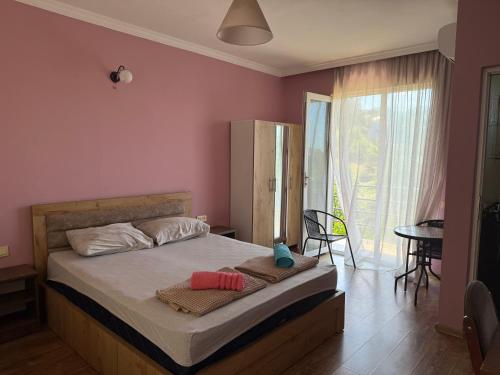 a bedroom with a bed with two towels on it at Maiko's House in Batumi