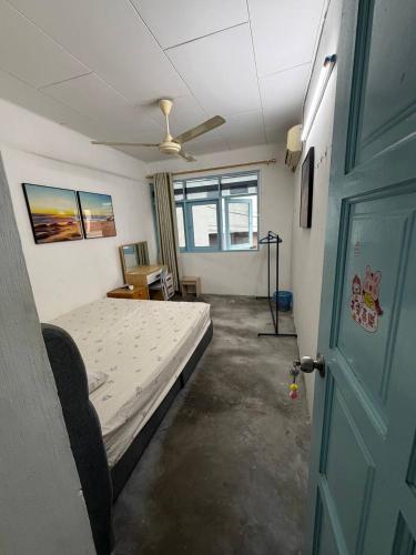a bedroom with a bed and a ceiling fan at Stellas house in Langkawi Islands