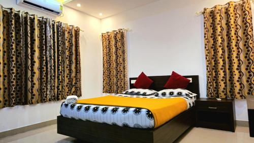 a bedroom with a bed in a room with curtains at Villas NEST Athirappilly in Athirappilly
