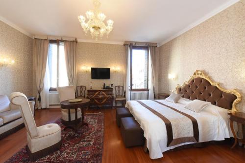 a bedroom with a large bed and a chandelier at 40.17 SAN MARCO in Venice