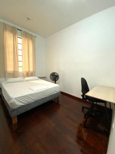a bedroom with a bed and a desk and a desk at Til Sunrise in Cali