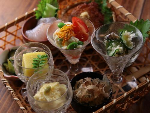 a tray of different types of food in glasses at SUNAORetreat奥白浜 in Minamiboso