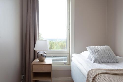 a bedroom with a bed and a window at Santasport Apartment Hotel in Rovaniemi