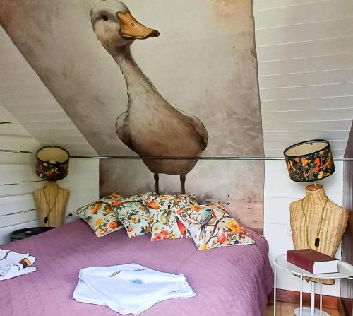 a duck standing on top of a bed at iNKiLAS KLIUKAI in Bijutiškis