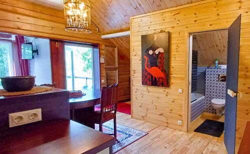 a kitchen with a dining table in a log cabin at iNKiLAS KLIUKAI in Bijutiškis
