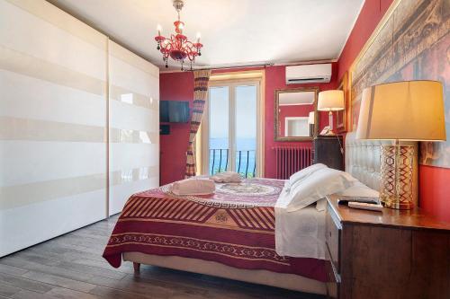 a bedroom with a bed and a table with a lamp at Villa Fuenti Bay - Amalfi Coast in Cetara