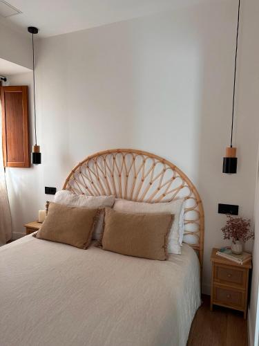 a bedroom with a large white bed with two pillows at Erreka Etxea in Murueta-Orozko