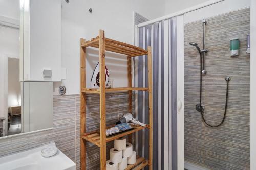 a bathroom with a shower and a wooden shelf at Tre Corone - Sarno in Sarno