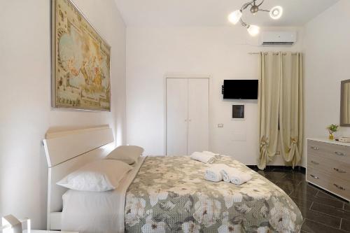a bedroom with a bed with two shoes on it at Tre Corone - Sarno in Sarno