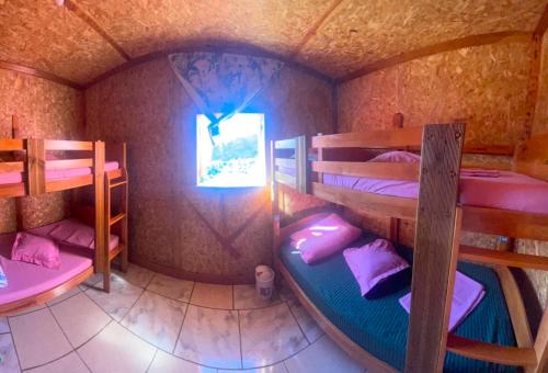 a room with three bunk beds and a window at Dortoirs in La Possession