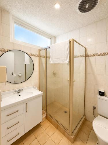 a bathroom with a shower and a sink at Pathfinder Motel in Melbourne