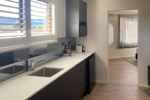 a kitchen with a sink and a counter top at Quality Hotel City Centre in Coffs Harbour