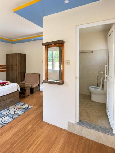 a room with a bed and a bathroom at Sukute River Hub Beach Resort in Dolālghāt
