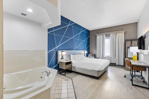 a hotel room with a bed and a sink and a tub at Comfort Inn & Suites FtJackson Maingate in Columbia