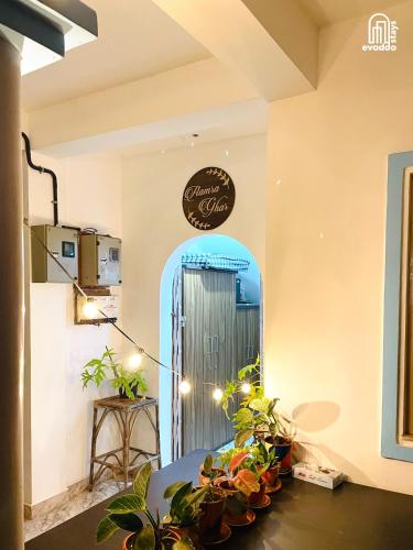 a room with a blue door and some plants at Aamra Ghar by evaddo stays in Mandrem