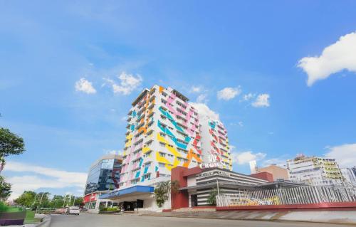a tall building with colorful windows in a city at Hotel Faranda Express Soloy and Casino, a member of Radisson Individuals in Panama City