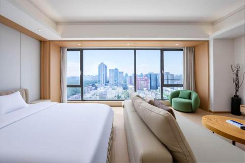 a hotel room with a bed and a large window at 栖雅民宿 in Beijing
