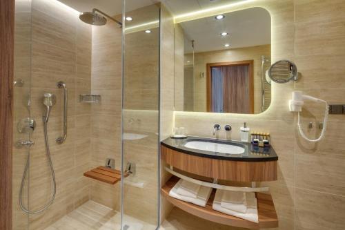 a bathroom with a sink and a shower at Ensana Esplanade in Piešťany