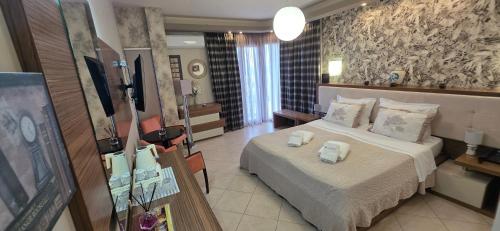a hotel room with a bed with towels on it at Porto Del Sol Hotel in Paralia Katerinis