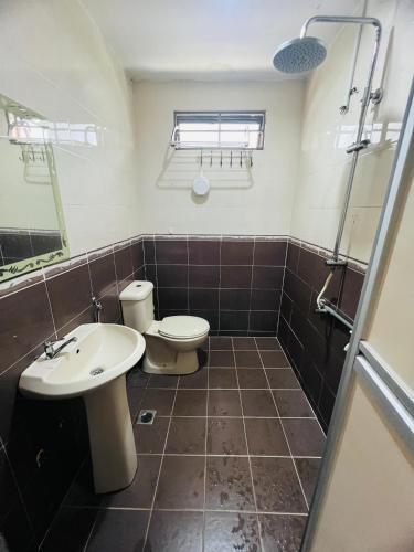 a bathroom with a toilet and a sink at FS Homestay Jitra in Jitra