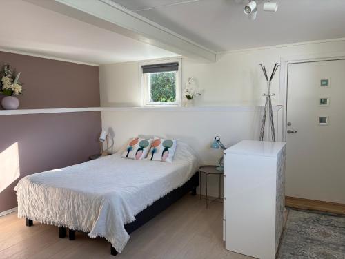 a bedroom with a bed with pillows and a window at Northern Suite in Tromsø
