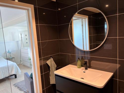 a bathroom with a sink and a mirror at Northern Suite in Tromsø