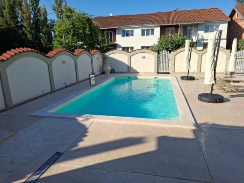 a swimming pool in a backyard with a white fence at Serbian home - free parking - Bazen se doplaćuje in Krnjača
