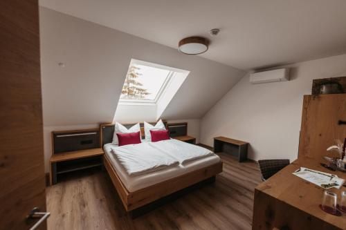 a bedroom with a bed and a skylight at Weingut Pugl in Leibnitz