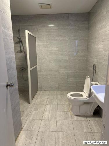 a bathroom with a toilet and a sink and a shower at marjan beach in Dhahran