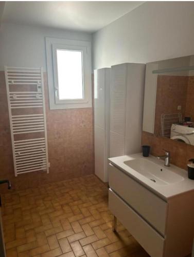a bathroom with a sink and a window at Nandys lounge in Yaoundé