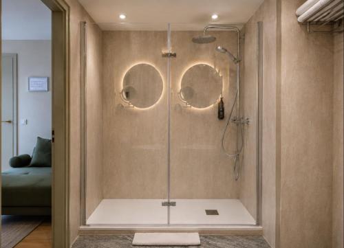 a shower with a glass door in a bathroom at De Herbert Amsterdam - Formerly France Hotel in Amsterdam