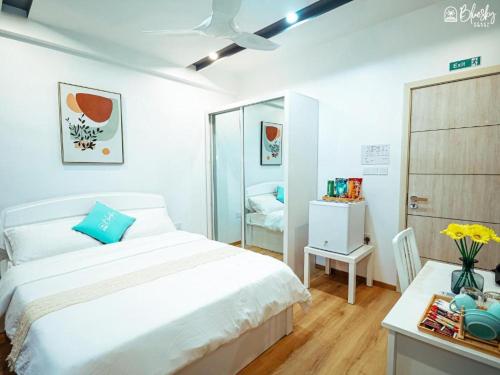 a white bedroom with a bed and a mirror at Blue Sky Beach in Hulhumale