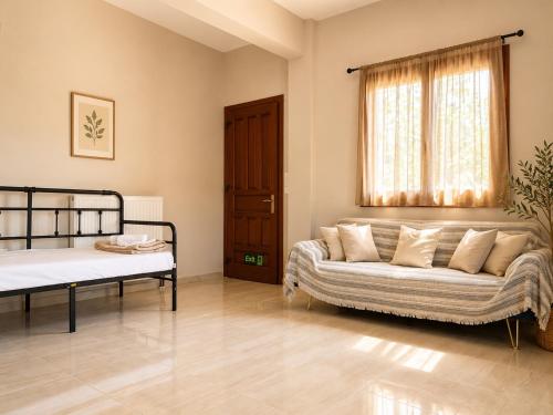 a living room with a couch and a bed at Villa Rozalia in Konitsa