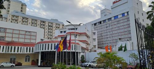 a building with flags in front of some buildings at Ambassador Pallava in Chennai