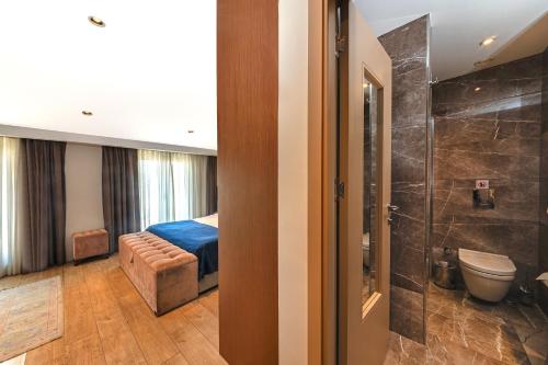 a hotel room with a bed and a bathroom at Redmont Hotel Nisantasi in Istanbul