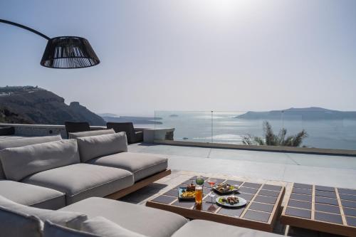 a living room with a couch and a table at Xenones Filotera in Imerovigli