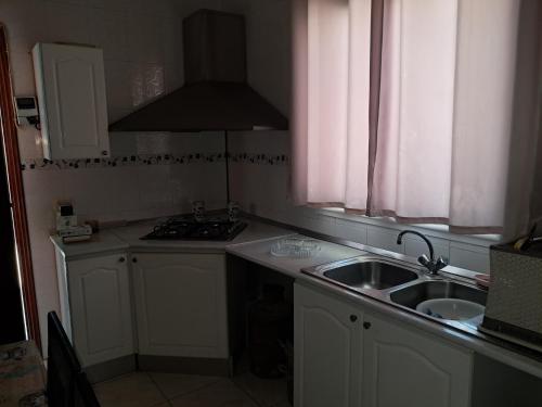 a kitchen with a sink and a stove at Domaine salma in Maherine