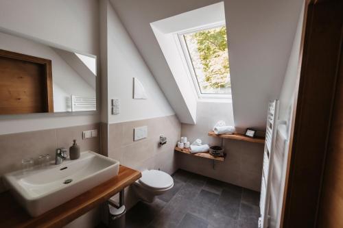 a bathroom with a sink and a toilet and a window at Weingut Pugl in Leibnitz