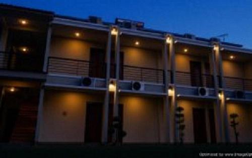 a building with lights on the side of it at night at Hastina Hotel Lombok in Mataram