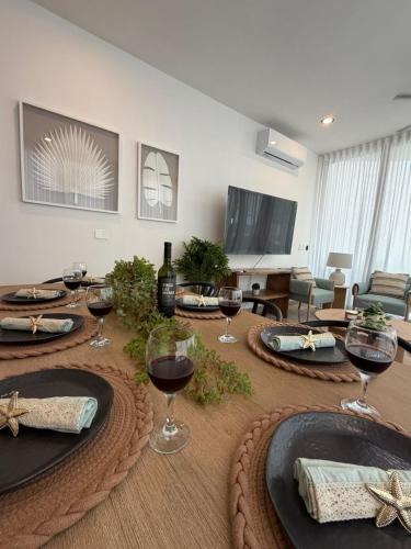 a table with wine glasses on top of it at Bajareque Oceanfront Luxury 3 BR Villa in Telchac Puerto