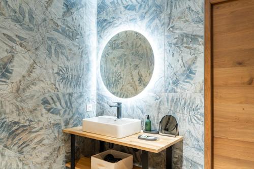 a bathroom with a sink and a mirror at Mille100-47 - Ubaye Base Camp in Faucon-de-Barcelonnette